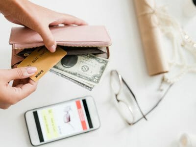 Young Woman Holding Nude Beige Leather Wallet