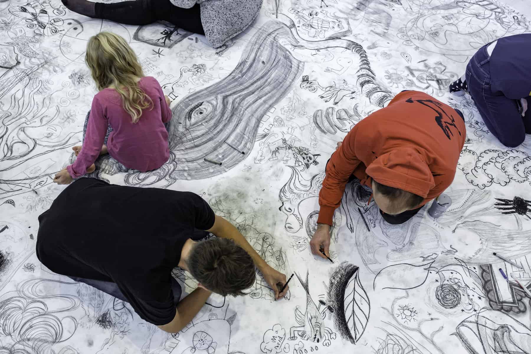 Three Children Drawing on Floor